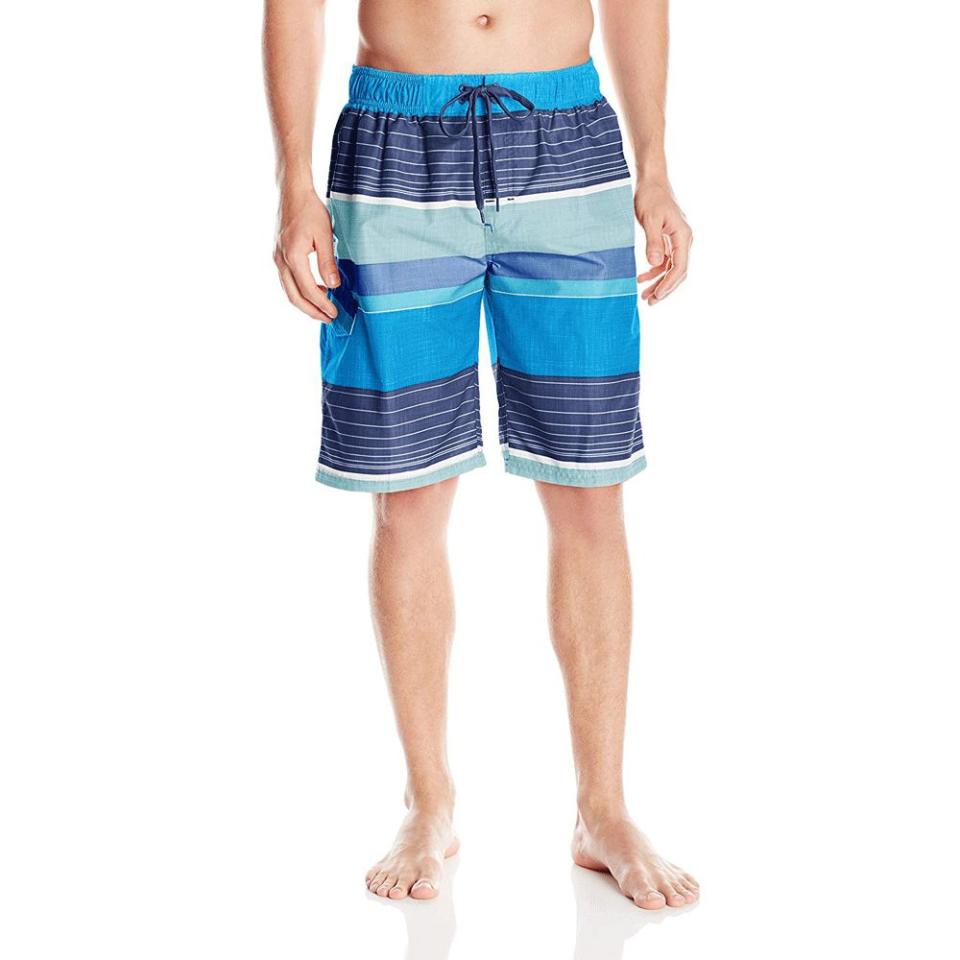 Person wearing multicolored swim trunks.