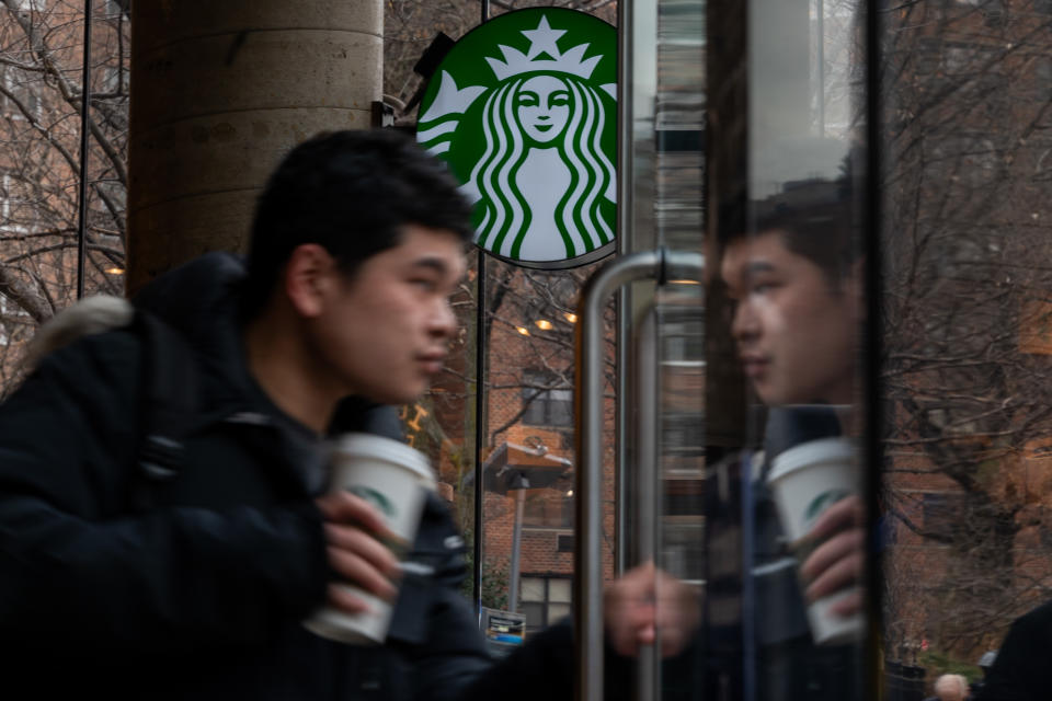 NEW YORK, NEW YORK - JANUARY 30: People exit a Starbucks store in Manhattan on January 30, 2024 in New York City. The global coffee chain officially introduced its extra virgin olive oil-infused drinks on Tuesday. Named Oleato, the drinks debuted in Italy in February 2023 and arrive in stores on the same day Starbucks will report fourth-quarter earnings. (Photo by Spencer Platt/Getty Images)