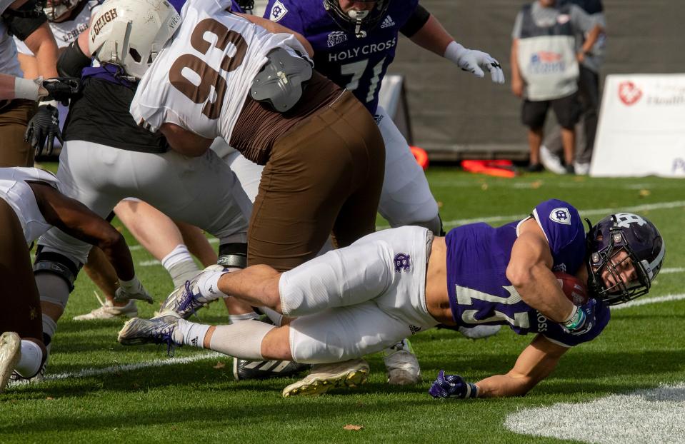 Jordan Fuller punches through the Lehigh defense to score the first Holy Cross touchdown in the first quarter Saturday.