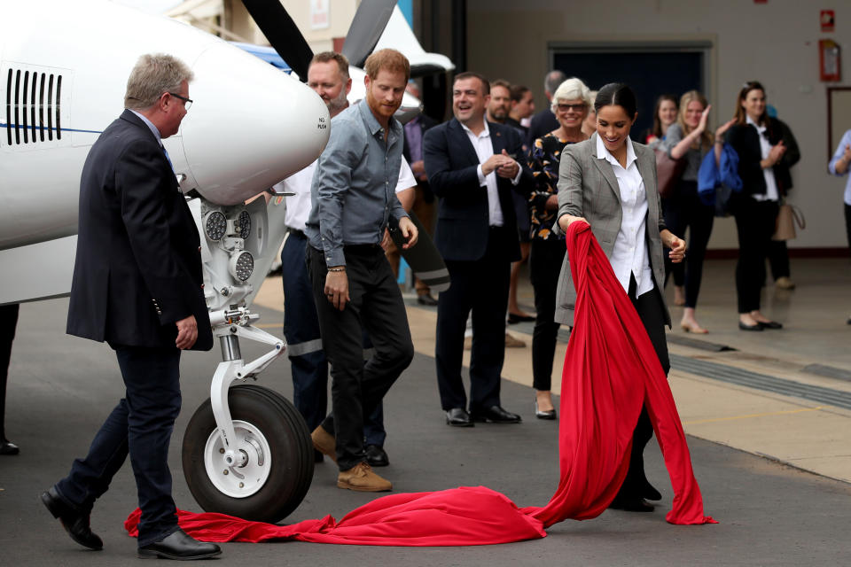 The Duke and Duchess of Sussex unveil a new plane at the Royal Flying Doctor Service in Dubbo. Photo: Getty, meghan markle prince harry dubbo, meghan markle prince harry australia, meghan markle serena williams jacket, meghan markle pregnant