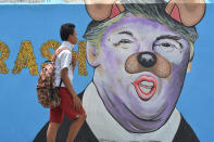 <p>A student passes in front of a mural depicting US President Donald Trump with a nose and ears like a dog at Palu on February 27, 2017 in Central Sulawei, Indonesia. (Photo: Sijori Images / Barcroft Images) </p>