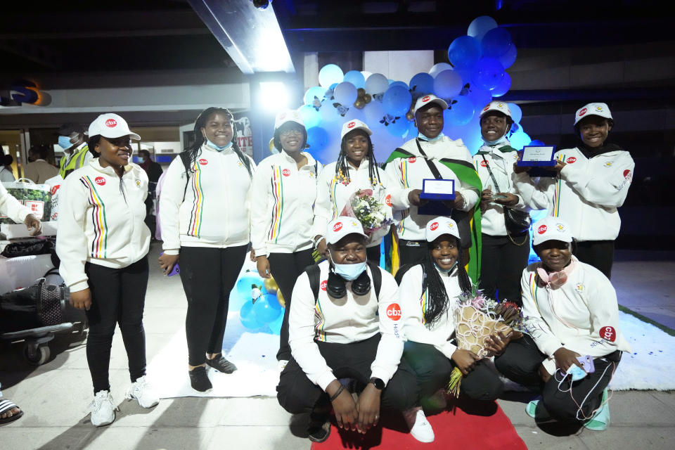 Zimbabwean high school World and European moot court competition champions pose for a photo as they arrive back at the Robert Mugabe International airport in Harare, Thursday, July, 7, 2022. A history-making team of Zimbabwean high school students that became world and European moot court competition champions has been widely praised in a country where the education system is beset by poor funding, lack of materials and teachers’ strikes. (AP Photo/Tsvangirayi Mukwazhi)