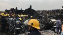 <p>Nepalese rescuers stand near a passenger plane from Bangladesh that crashed at the airport in Kathmandu, Nepal, March 12, 2018. (Photo: Niranjan Shreshta/AP) </p>