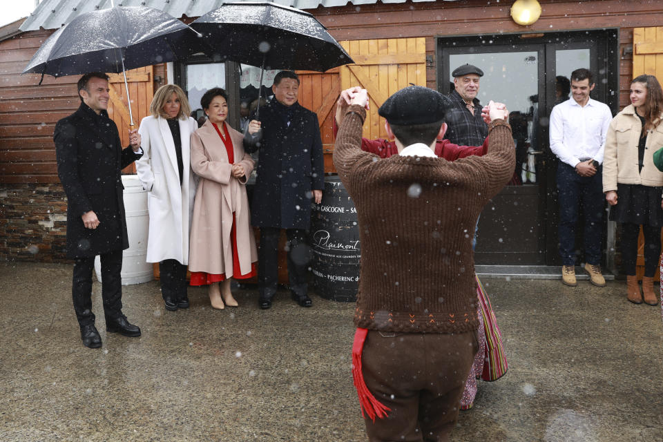 French President Emmanuel Macron and his wife Brigitte Macron, Chinese President Xi Jinping, and his wife Peng Liyuan watch folklore dancers, Tuesday, May 7, 2024 at the Tourmalet pass, in the Pyrenees mountains. French president is hosting China's leader at a remote mountain pass in the Pyrenees for private meetings, after a high-stakes state visit in Paris dominated by trade disputes and Russia's war in Ukraine. French President Emmanuel Macron made a point of inviting Chinese President Xi Jinping to the Tourmalet Pass near the Spanish border, where Macron spent time as a child visiting his grandmother. (AP Photo/Aurelien Morissard, Pool)