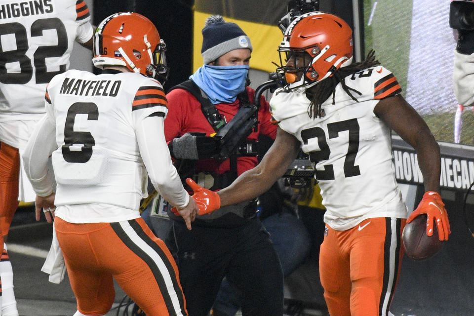 Cleveland Browns running back Kareem Hunt (27) celebrates with quarterback Baker Mayfield (6) after scoring on an eight-yard run during the first half of an NFL wild-card playoff football game against the Pittsburgh Steelers in Pittsburgh, Sunday, Jan. 10, 2021. (AP Photo/Don Wright)