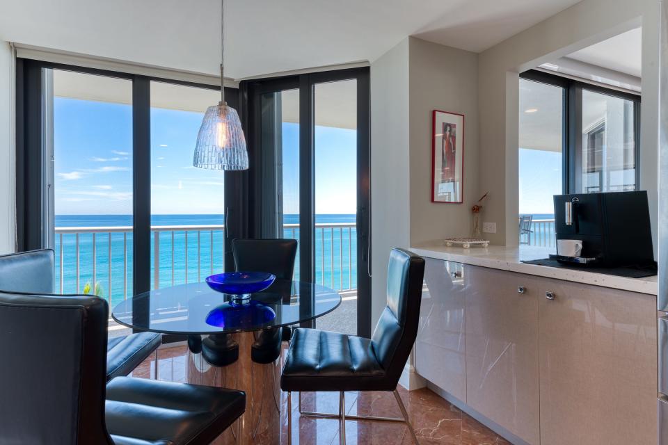 At the far end of the kitchen, the breakfast area offers an ocean view.