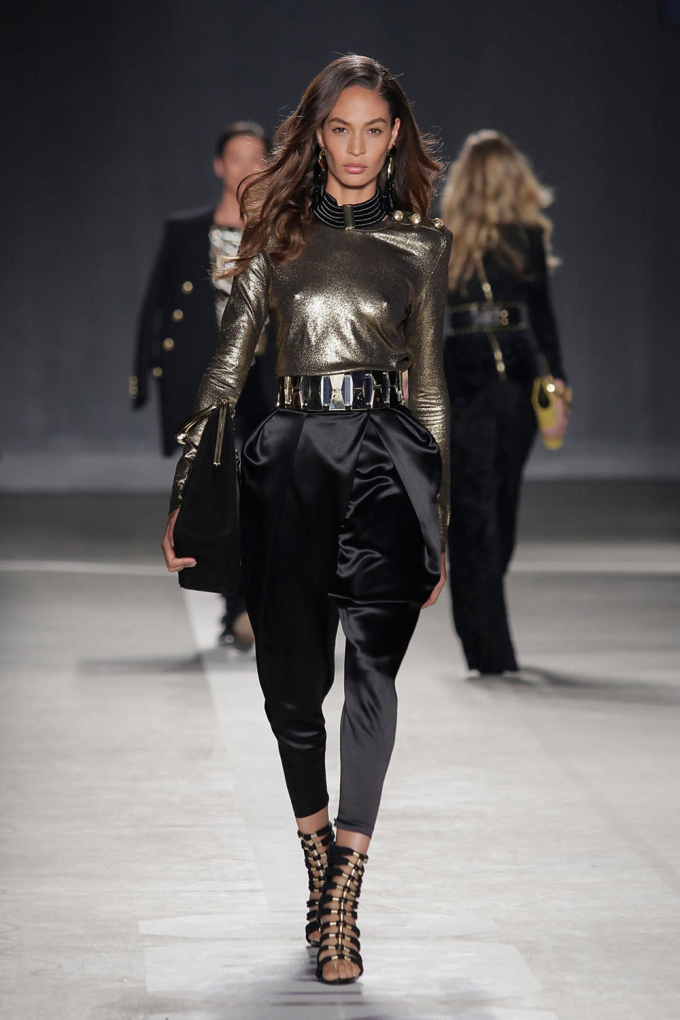 Model Joan Smalls walks the runway at Balmain x H&M. 