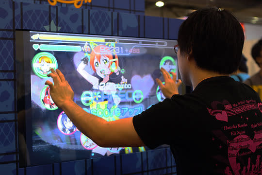 A fan of the ‘LoveLive!’ anime playing the anime’s music game. (Photo: Sharlene Sankaran/Yahoo Singapore)