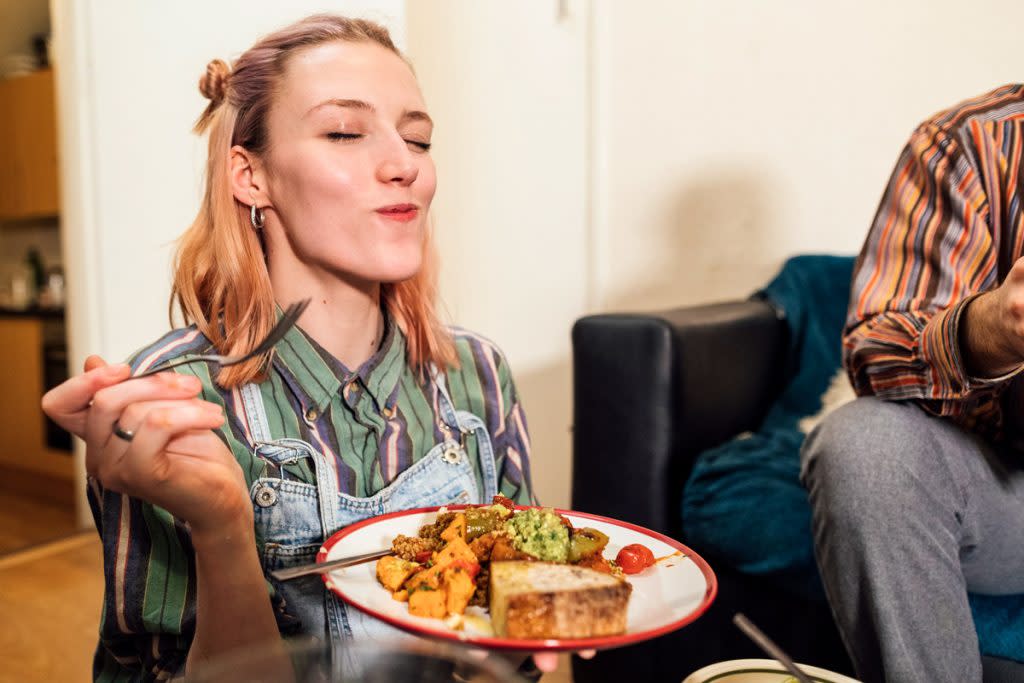 A woman eats food.