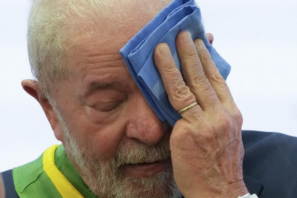 President Luiz Inacio Lula da Silva wipes his face after he was sworn in as new president at the Planalto Palace in Brasilia, Brazil, Sunday, Jan. 1, 2023. (AP Photo/Eraldo Peres)