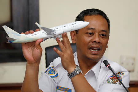 FILE PHOTO: Indonesia’s National Transportation Safety Committee (KNKT) sub-committee head for air accidents, Nurcahyo Utomo, holds a model airplane while speaking during a news conference on its investigation into a Lion Air plane crash last month, in Jakarta, Indonesia November 28, 2018. REUTERS/Darren Whiteside/File Photo