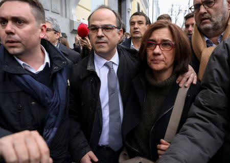 Catalan politician Jordi Turull walks with his wife Blanca Bragulat after leaving the Supreme Court where he appeared before a judge as part of an investigation for his part in Catalonia's bid for independence in Madrid, Spain, March 23, 2018. REUTERS/Susana Vera