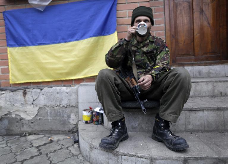 A Ukrainian "Right Sector" volunteer takes a rest at his position near the village of Peski, next to Donetsk's airport, on November 13, 2014