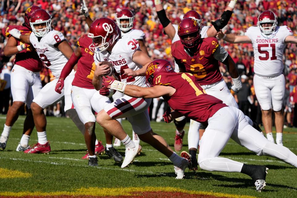 OU kicker Zach Schmit (34) runs from Iowa State defensive back Beau Freyler (17) while scoring a touchdown on a fake field-goal attempt during the first half Saturday in Ames, Iowa.