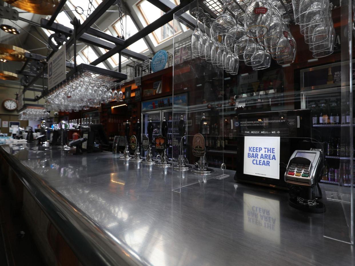 A protective shield for customers surrounds the card payment machine at the bar of a Wetherspoons pub in Muswell Hill, London, ahead of pubs reopening on 4 July: Yui Mok/PA Wire