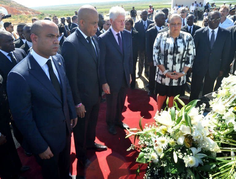 From L to R, Haitian Prime Minister Laurent Lamorthe, Haitian President Michel Martelly, UN special envoy to Haiti former US president Bill Clinton and Haitian First Lady Sophia Martelly observe a minute of silence on January 12, 2013 in Titanyin, 14km from Port-au-Prince, at a communal grave for a memorial ceremony in honor of the victims of the January 12, 2010 earthquake in Haiti