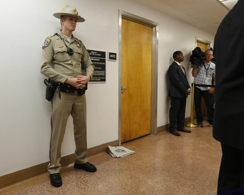 A California highway patrol officer stands outside the office of Sen. Leland Yee, D-San Francisco, at the state Capitol, Wednesday, March 26, 2014, in Sacramento, Calif. FBI spokesman Peter Lee said Yee was arrested Wednesday, he declined to discuss the charges, citing an ongoing investigation. (AP Photo/Rich Pedroncelli)