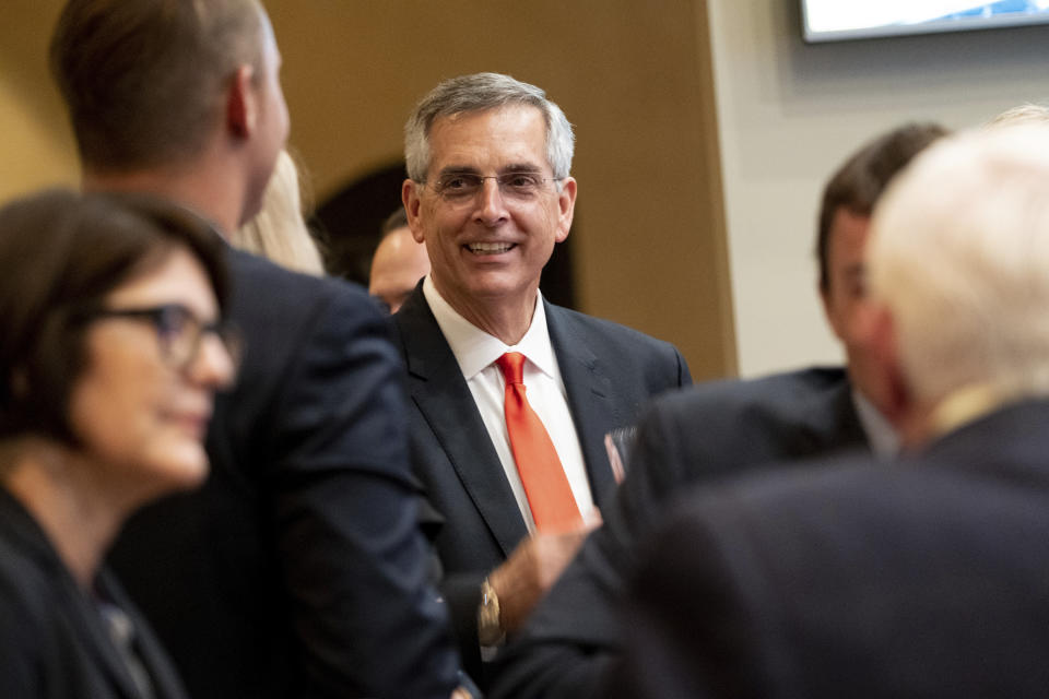 Incumbent Georgia Secretary of State Brad Raffensperger talks with supporters during an election night party Tuesday evening, May 24, 2022, at a small restaurant in Peachtree Corners, Ga. (AP Photo/Ben Gray)