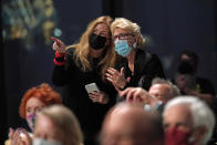 Members of the audience chat at the conclusion of a live performance by the New York Philharmonic after the orchestra performed together before a crowd of 150 socially-distanced spectators for the first time since March 10, 2020, at The Shed in Hudson Yards, Wednesday, April 14, 2021, in New York. (AP Photo/Kathy Willens)