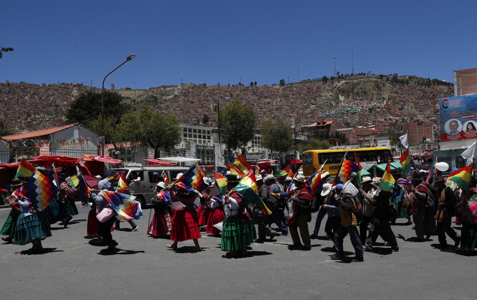 Supporters of Bolivian President Evo Morales march in La Paz, Bolivia, Wednesday, Oct. 23, 2019. Bolivian President Evo Morales said Wednesday his opponents are trying to stage a coup against him as protests grow over a disputed election he claims he won outright, though a nearly finished vote count suggests it might head to a second round.(AP Photo/Juan Karita)