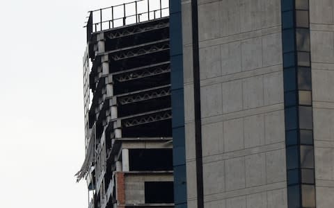 An unfinished, abandoned skyscraper in Caracas leaning following the quake  - Credit: Federico Parra /AFP