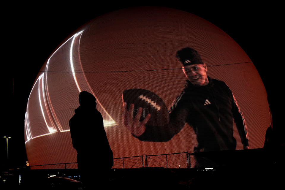 A man watches an advertisement featuring Kansas City Chiefs quarterback Patrick Mahomes on the Sphere Tuesday, Feb. 6, 2024 in Las Vegas. The Chiefs are scheduled to play the San Francisco 49ers in Super Bowl 58 Sunday. (AP Photo/Charlie Riedel)