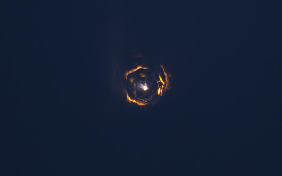 A huge rocket exploding during stage separation, with fiery plumes in all directions.