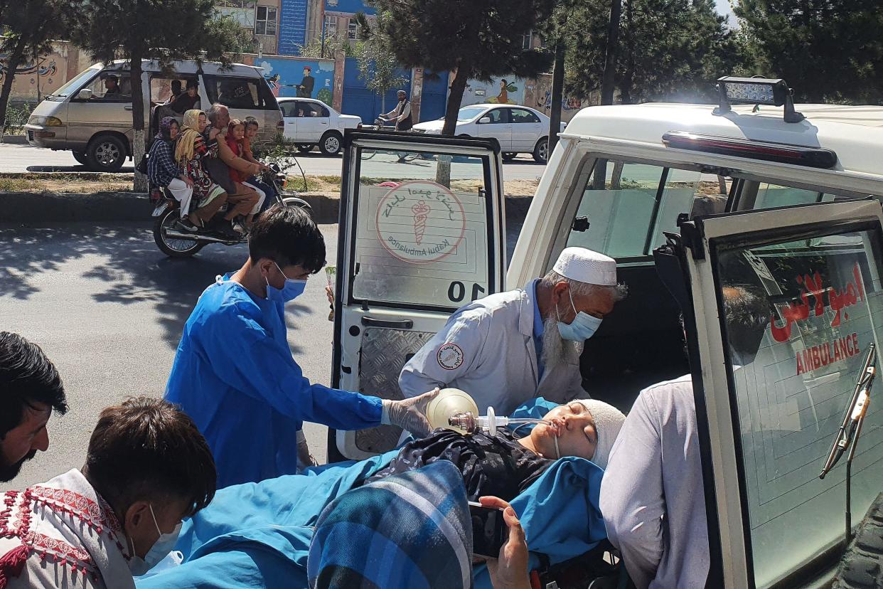 Relatives and medical staff remove a wounded girl from an ambulance outside a hospital in Kabul, September 30, 2022, following a suicide blast at a learning center in the Dasht-e-Barchi area of Afghanistan's capital. / Credit: AFP via Getty