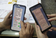 Volunteers of Fake News Cleaner guide students through the LINE app to identify fake news during a class in Kaohsiung City, southern Taiwan, Thursday, March 16, 2023. An anti-misinformation group in Taiwan called Fake News Cleaner has hosted more than 500 events, connecting with college students, elementary-school children — and the seniors that, some say, are the most vulnerable to such efforts. (AP Photo/Chiang Ying-ying)