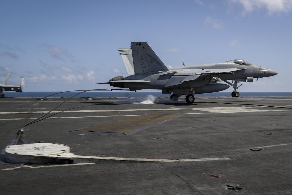 In this Monday, May 20, 2019 photo, an F/A-18E Super Hornet from the ìFist of the Fleetî of Strike Fighter Squadron (VFA) 25 lands on the flight deck of the Nimitz-class aircraft carrier USS Abraham Lincoln in the Arabian Sea. (Mass Communication Specialist 3rd Class Jeff Sherman/U.S. Navy via AP)