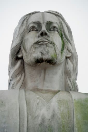 The "Christ of the Pacific" statue appears neglected and dirty, in stark contrast to two military monuments located nearby