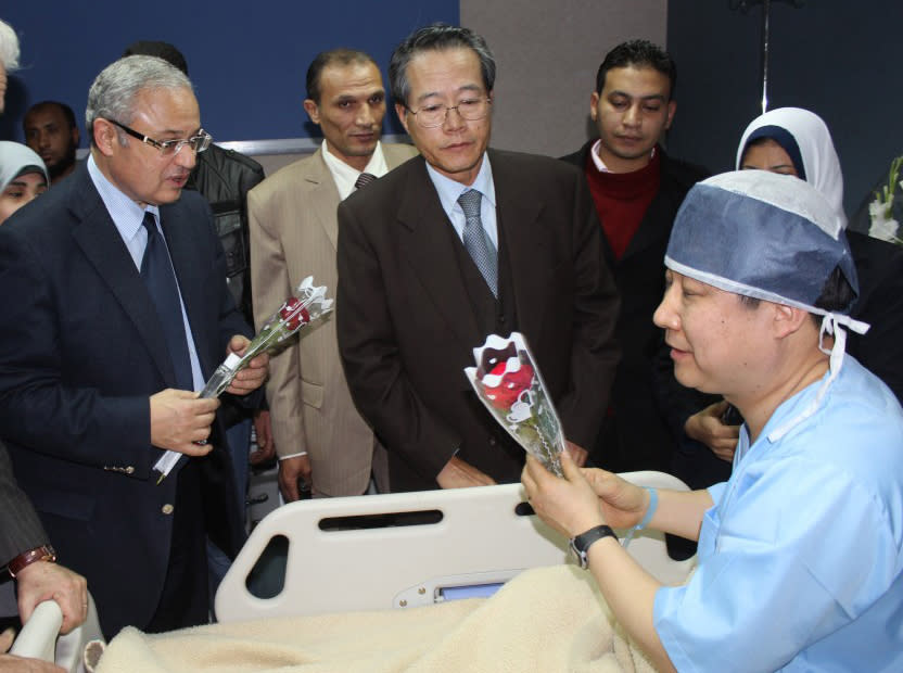 In this photo released by the office of the South Sinai governor, Egyptian Minister of Tourism Hesham Zazou, left, and Deputy Chief of Mission of the South Korean Embassy in Egypt, Mr. Kwon Sae Young, center, visit a South Korean tourist who was injured during an explosion that targeted a tourist bus, as he received medical treatment in a Sharm El-Sheik hospital, in Egypt, late Sunday, Feb. 16, 2014. An explosion ripped through a tourist bus near a border crossing between Egypt and Israel in the Sinai Peninsula, killing four South Koreans and the Egyptian driver, security officials said. (AP Photo/Office of the South Sinai Governor)