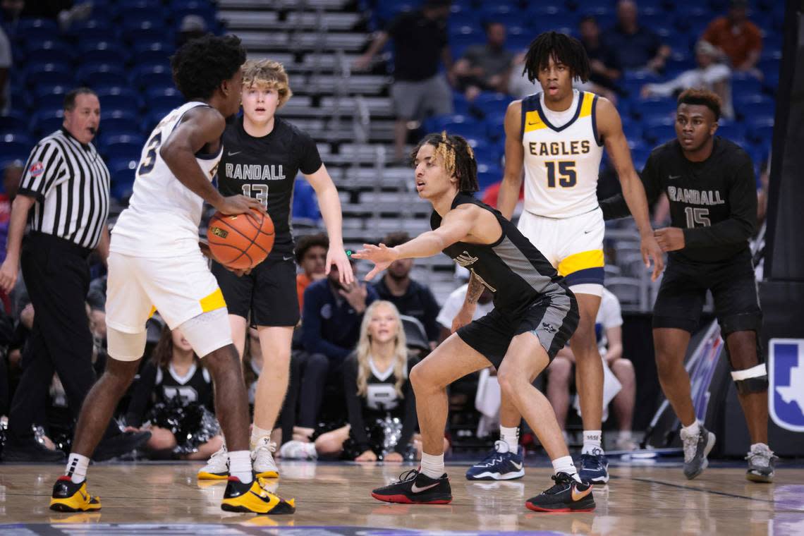 Dallas Oak Cliff Faith Family’s Jazz Henderson (3) looks to get the ball inside to Jadyn Toppin (15 in white) as Amarillo Randalll’s J.J. Buchanan (4), Brody Wilson (13) and Devin Baccas (15 in black) defend in the Class 4A state semifinals on Friday, March 10, 2023 at the Alamodome in San Antonio, Texas.