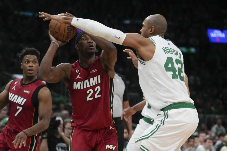 Miami Heat forward Jimmy Butler (22) looks to pass against Boston Celtics center Al Horford (42) in the first half of Game 1 of the NBA basketball Eastern Conference finals playoff series in Boston, Wednesday, May 17, 2023. (AP Photo/Charles Krupa)