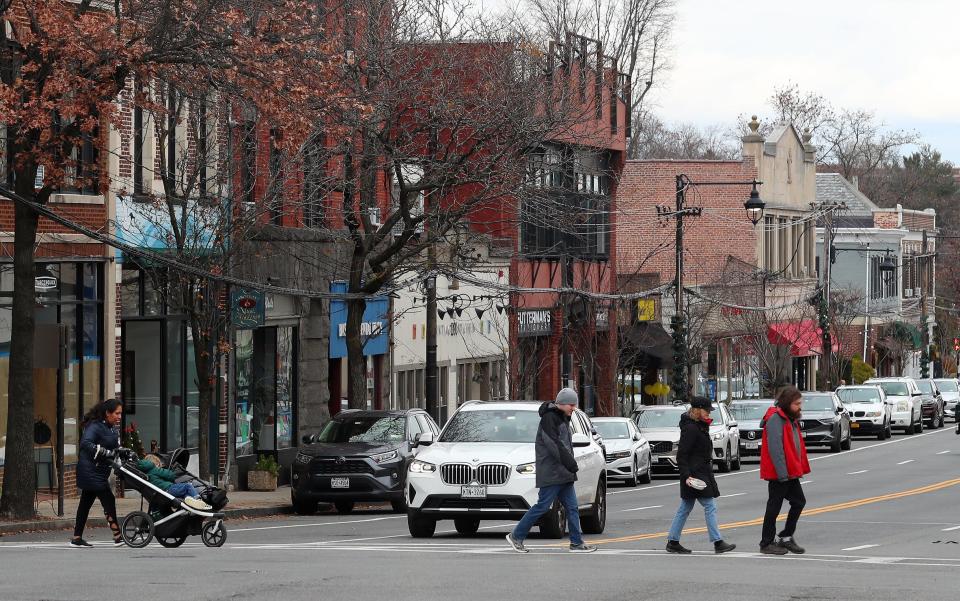 People cross Larchmont Ave and Boston Post Road in downtown Larchmont Dec. 6, 2023.