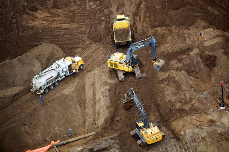 FILE PHOTO: Heavy earth moving equipment work clearing an area at the new Suncor Fort Hills tar sands mining operations near Fort McMurray.