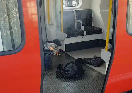 Personal belongings and a bucket with an item on fire inside it on the floor of an underground train carriage at Parsons Green station in West London. Sylvain Pennec/via REUTERS