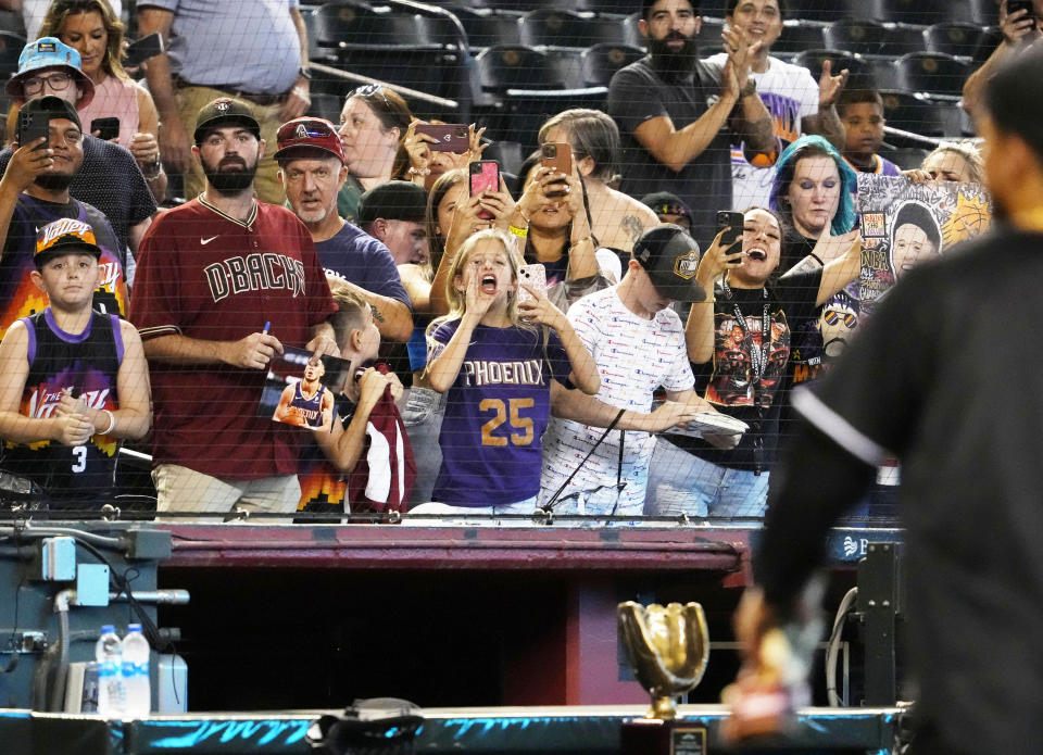 Jun 22, 2022; Phoenix, Arizona, USA; Phoenix Suns fans react as Devin Booker arrives on the field  during the Water for Life Charity Softball Game hosted by JaVale McGee and his Juglife Foundation at Chase Field. Mandatory Credit: Rob Schumacher-Arizona Republic