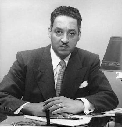 NAACP lawyer Thurgood Marshall sits behind his desk in 1952. <a href="https://www.gettyimages.com/detail/news-photo/portrait-of-american-lawyer-and-special-counsel-of-the-news-photo/666092350?adppopup=true" rel="nofollow noopener" target="_blank" data-ylk="slk:PhotoQuest/Getty Images;elm:context_link;itc:0;sec:content-canvas" class="link ">PhotoQuest/Getty Images</a>