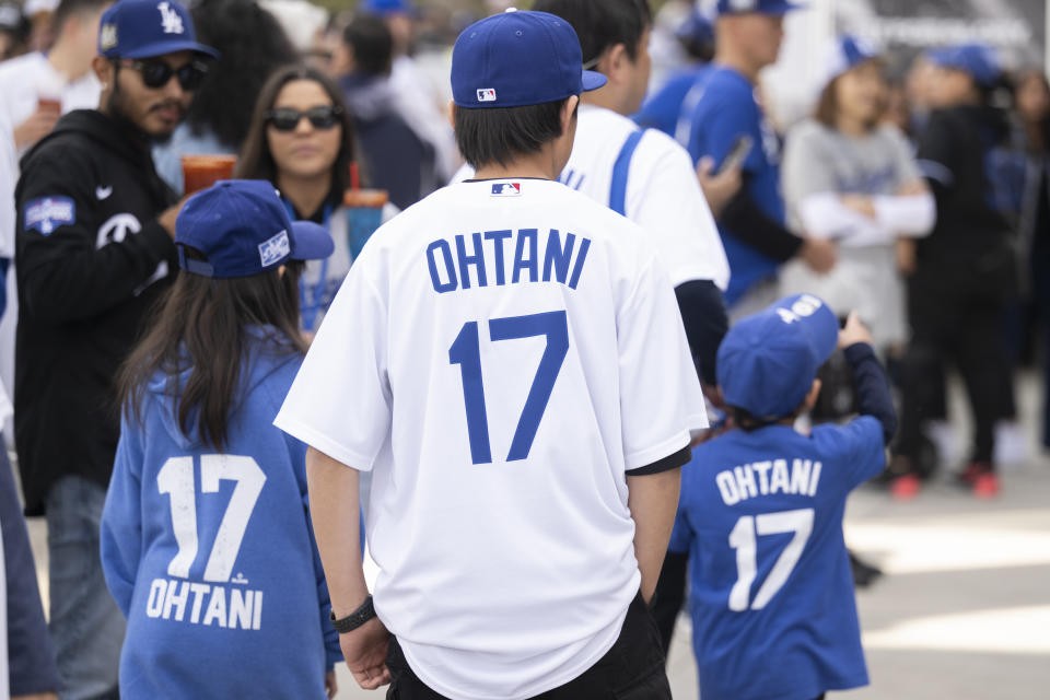 Los Angeles Dodgers fans with Shohei Ohtani merchandise attend the team's fan fest in Los Angeles, Saturday, Feb. 3, 2024. (AP Photo/Kyusung Gong)