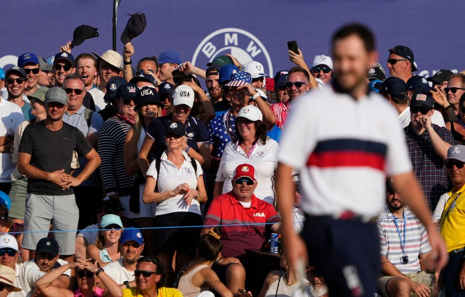 Sep 30, 2023; Rome, ITALY;  Fans hold up hats towards Team USA golfer Patrick Cantlay on the 12th green during day two fourballs round for the 44th Ryder Cup golf competition at Marco Simone Golf and Country Club. Mandatory Credit: Adam Cairns-USA TODAY Sports