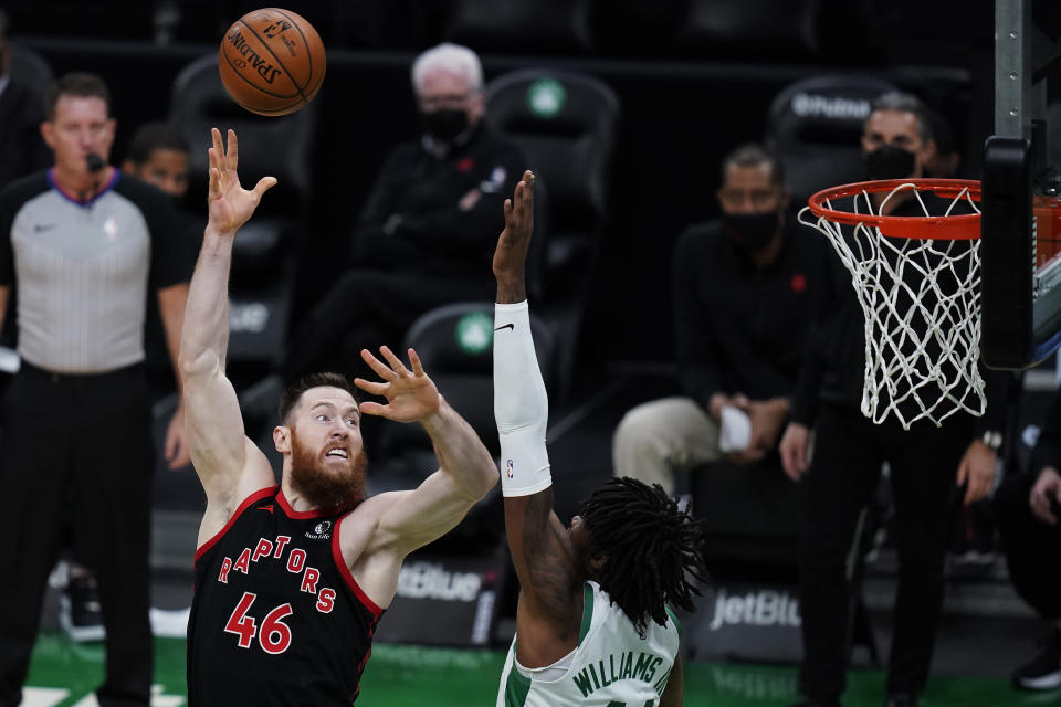 Toronto Raptors center Aron Baynes (46) shoots over Boston Celtics center Robert Williams III during the first half of an NBA basketball game, Thursday, March 4, 2021, in Boston. (AP Photo/Charles Krupa)