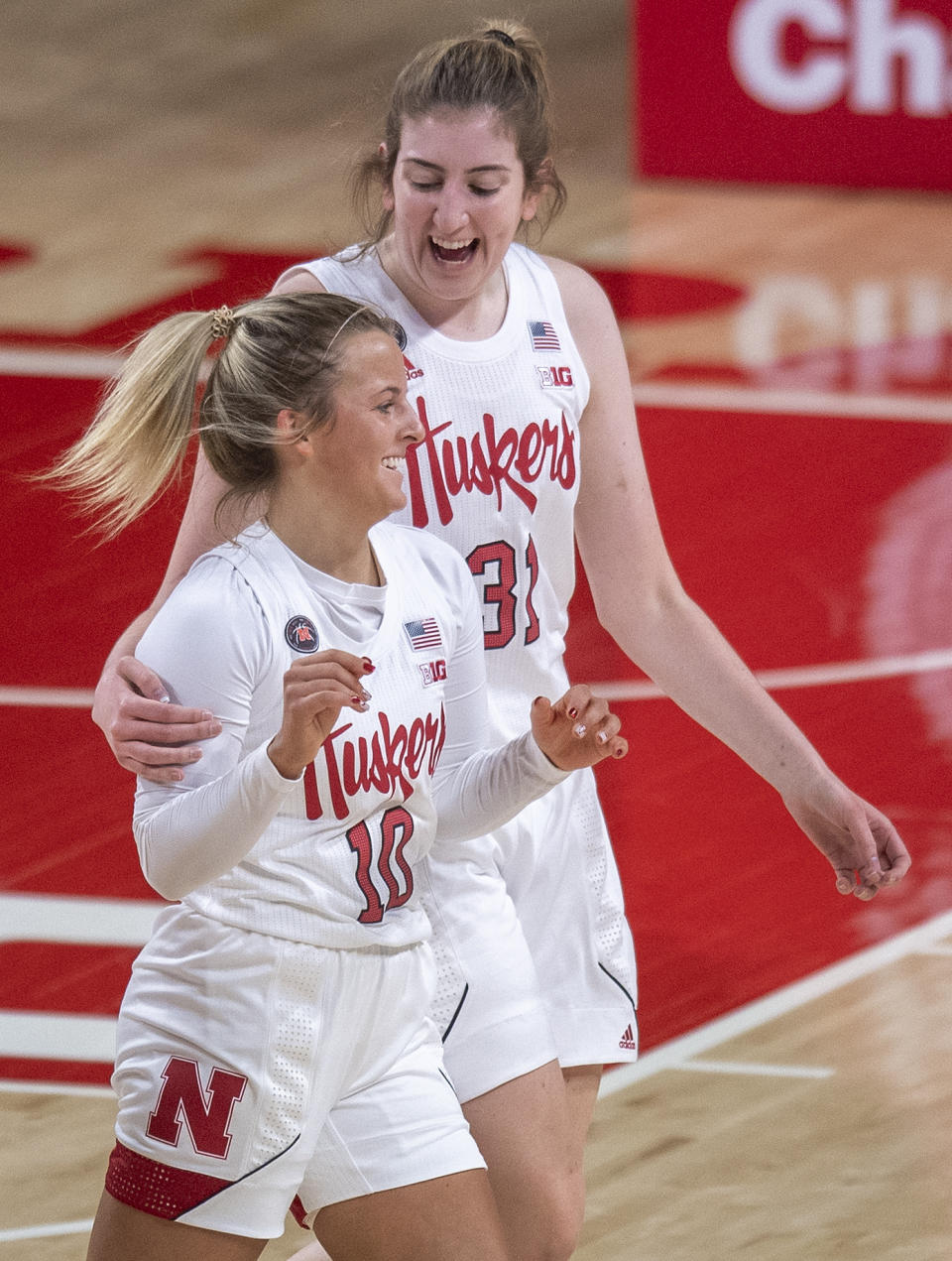 Nebraska's Whitney Brown (10) celebrates her second three-point basket against Northwestern in the first half with teammate Kate Cain (31) during an NCAA college basketball game Thursday, Dec. 31, 2020, in Lincoln, Neb. (Francis Gardler/Lincoln Journal Star via AP)