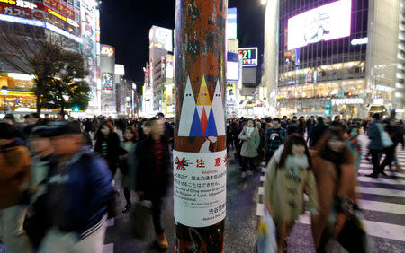 A sticker art depicting U.S. President Donald Trump, made by a Japanese graffiti artist known as 281 Antinuke, is seen at a busy crossing in Tokyo's Shibuya shopping and entertainment district, Japan, January 27, 2017. REUTERS/Toru Hanai