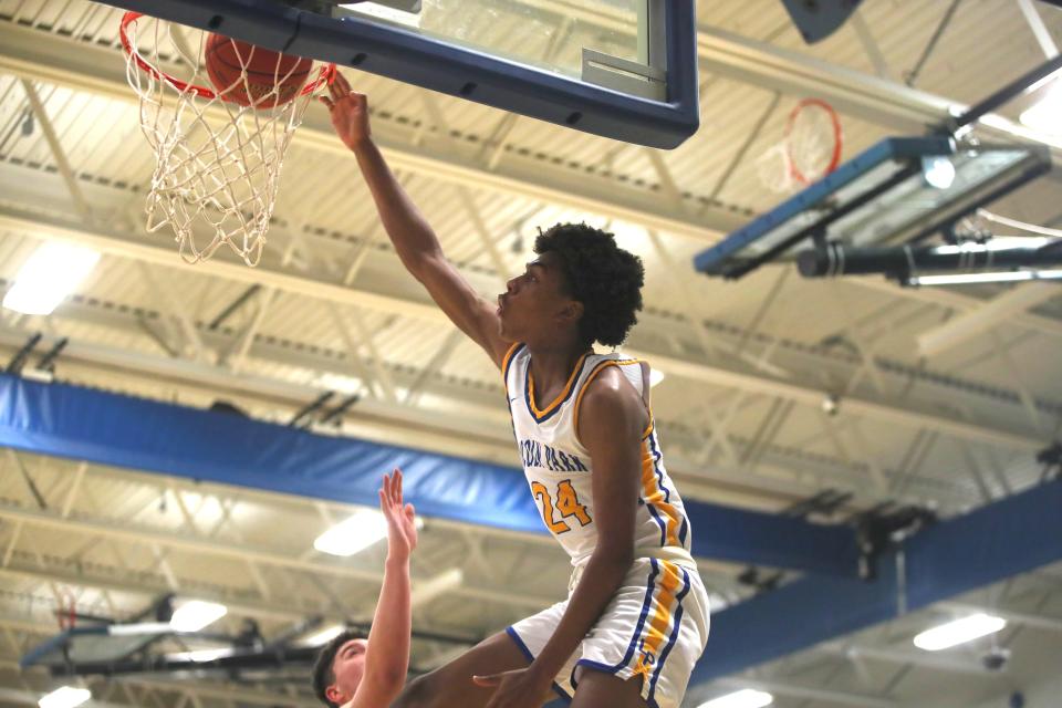 Lincoln Park's Brandin Cummings attempts to dunk the ball while being guarded by Central's Seth Bean (45) during the first half of the PIAA 4A Playoff game Tuesday night at Lincoln Park Performing Arts Charter School.