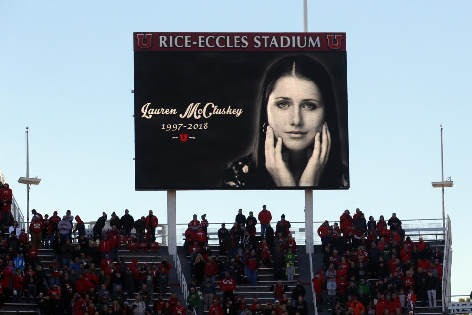 FILE - In this Nov. 10, 2018, file photo, a photograph of University of Utah student and track athlete Lauren McCluskey, who was fatally shot on campus, is projected on the video board before the start of an NCAA college football game between Oregon and Utah in Salt Lake City. The parents of a University of Utah student killed on campus by an ex-boyfriend said Monday they feel a fresh sense of betrayal after new allegations surfaced that a police officer investigating her report kept explicit photos that were intended as evidence. (AP Photo/Rick Bowmer, File)