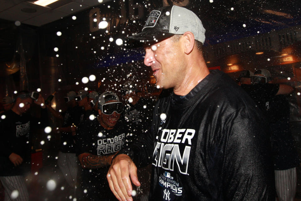 Sep 19, 2019; Bronx, NY, USA; New York Yankees manager Aaron Boone is sprayed with champagne as he celebrates after winning the American League East after defeating the Los Angeles Angels at Yankee Stadium. Mandatory Credit: Brad Penner-USA TODAY Sports