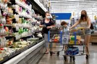 FILE PHOTO: FILE PHOTO: Shoppers are seen wearing masks while shopping at a Walmart store in Bradford, Pennsylvania