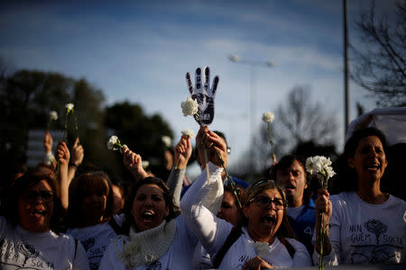 Nurses dressed in white holding white carnations are seen during a protest march in Lisbon, Portugal, March 8, 2019. REUTERS/Pedro Nunes