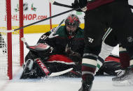 Arizona Coyotes goalie Scott Wedgewood (31) covers up the puck while making a save against the Dallas Stars during the second period of an NHL hockey game Saturday, Nov. 27, 2021, in Glendale, Ariz. (AP Photo/Darryl Webb)